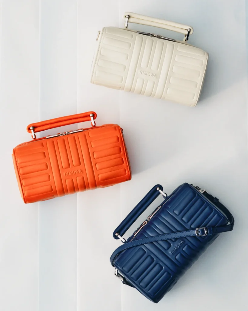 RIMOWA Groove leather bags in Ink Blue, orange and cream.