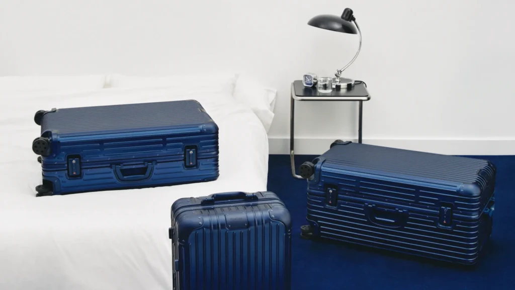 RIMOWA Ink Blue Original suitcases in three sizes in a blue interior.
