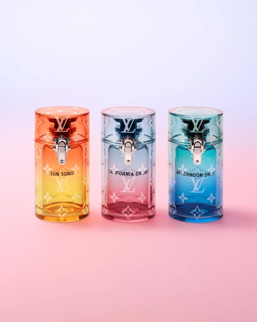 Three colorful Louis Vuitton x Alex Israel translucent resin travel cases for Sun Song, California Dream, and Afternoon Swim perfumes.