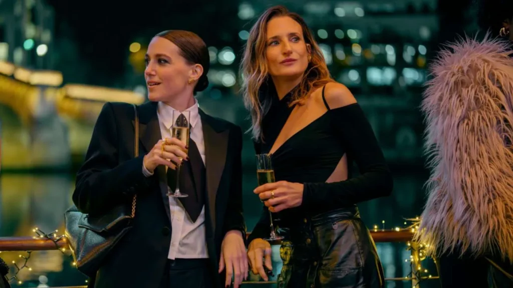 Fanny Sidney as Camille Valentini (left) and Camille Cottin as agent Andrea Martel (right) holding a glass of champagne in Paris in the Call My Agent movie.